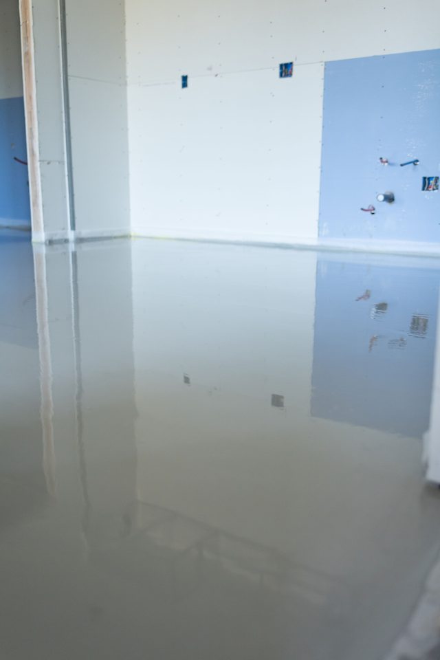 Wet gypsum pour at a kitchen plumbing wall